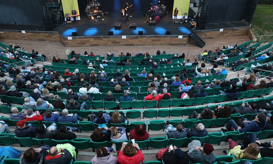 epa09033861 People wearing face masks during a music concert after showing their coronavirus vaccination certificate or &#039;green badge&#039; in Tel Aviv, 24 February 2021. Israel reopened cultural  ...