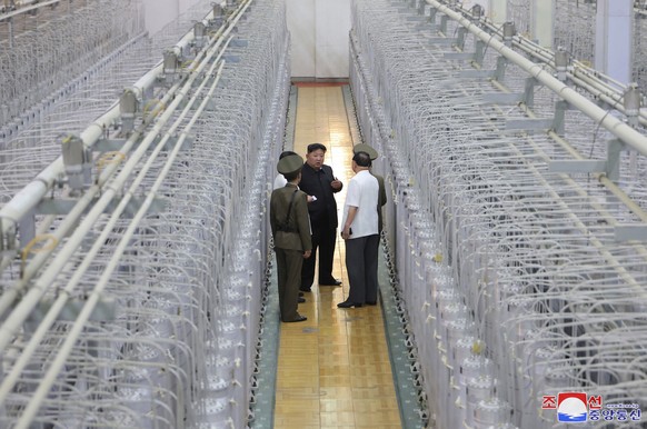 This undated photo provided on Friday, Sept. 13, 2024, by the North Korean government shows its leader Kim Jong Un, center, on an inspecting visit at what they say is an institute of nuclear weapons a ...