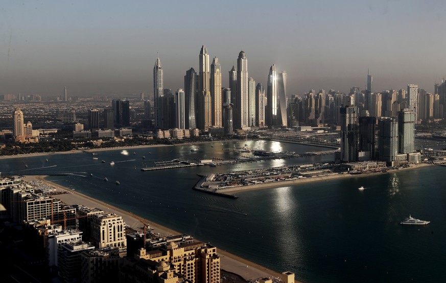 FILE - Luxury towers that dominate the skyline in the Dubai Marina district, center, and the new Dubai Harbor development, right, are seen from the observation deck of &quot;The View at The Palm Jumei ...
