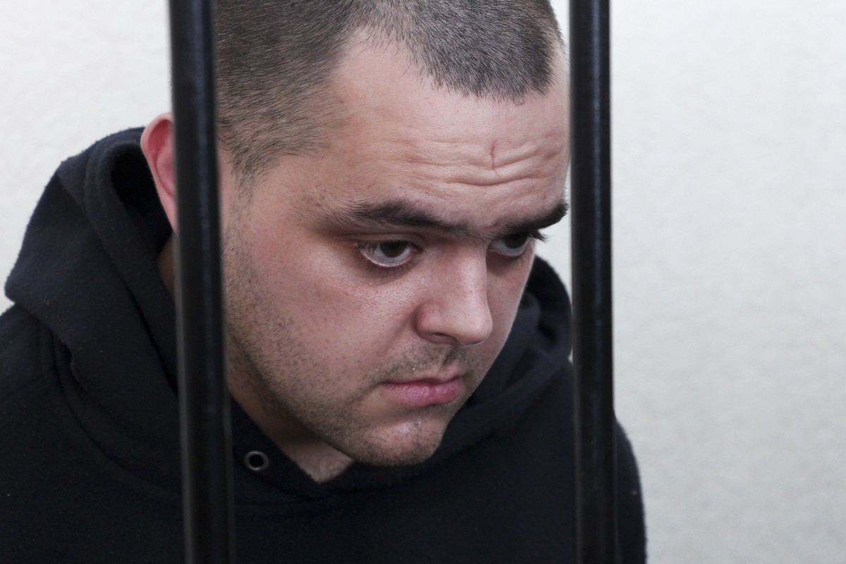 FILE - British citizen Aiden Aslin stands behind bars in a courtroom in Donetsk, in the territory which is under the Government of the Donetsk People's Republic control, eastern Ukraine, on June  ...