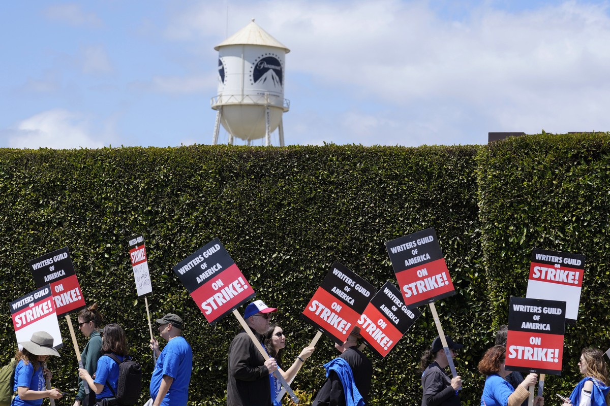 FILE - Striking writers take part in a rally in front of Paramount Pictures studio, Tuesday, May 2, 2023, in Los Angeles. A tentative deal was reached, Sunday, Sept. 24, 2023, to end Hollywood?s write ...