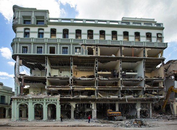 epa09934818 Rescue work continues at the destroyed Saratoga hotel, in Havana, Cuba, 08 May 2022. The health authorities raised the number of deaths to 30 in the explosion caused by a gas leak. The res ...