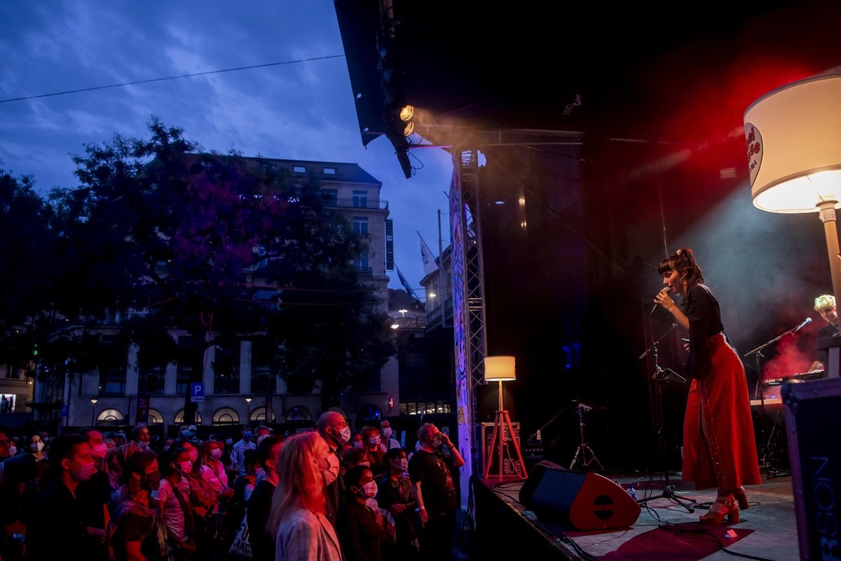 Des festivaliers avec des masques ecoutent la chanteuse Giulia Dabala, qui chante sur la scene de la place Centrale lors du festival Label Suisse le samedi 19 septembre 2020 a Lausanne. (KEYSTONE/Jean ...