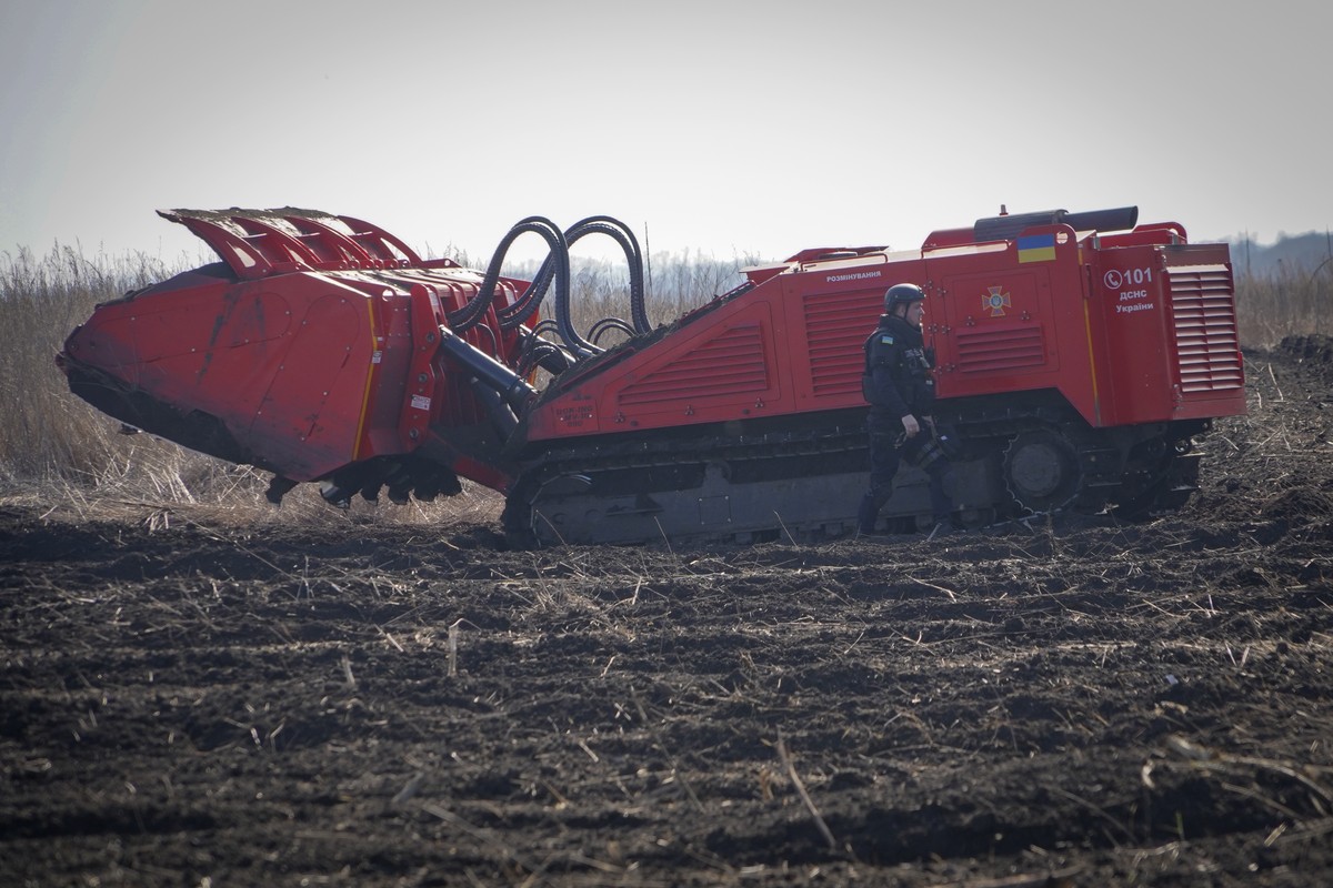 A Ukrainian Emergency Situation sapper works with a Croatia-made DOK-ING MV-10 mine-clearing machine to clear the site of mines and other explosives after battles with the Russian troop, near Balaklia ...