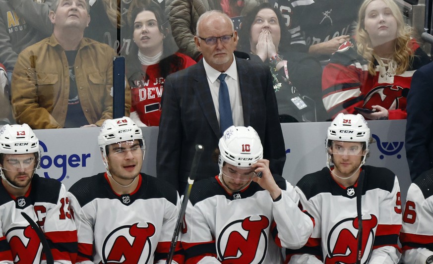 New Jersey Devils coach Lindy Ruff, top center, watches his team play against the Columbus Blue Jackets during the third period an NHL hockey game in Columbus, Ohio, Saturday, Dec. 16, 2023. (AP Photo ...