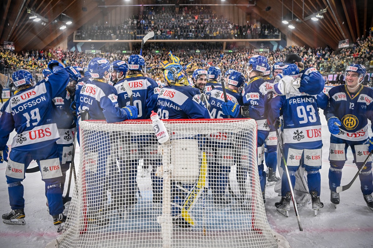 Davos' players celebrate after winning the final game between Switzerland's HC Davos and HC Dynamo Pardubice, at the 95th Spengler Cup ice hockey tournament in Davos, Switzerland, on Sunday, ...