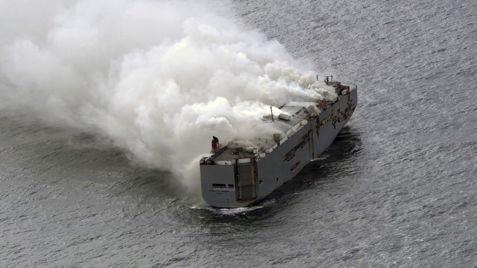 Smoke is seen from a freight ship in the North Sea, about 27 kilometers (17 miles) north of the Dutch island of Ameland, Wednesday, July 26, 2023. A fire on the freight ship Fremantle Highway, carryin ...