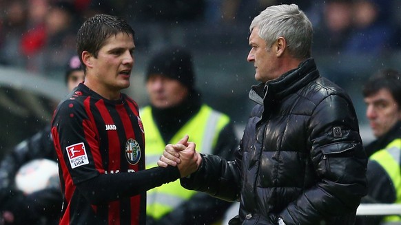 FRANKFURT AM MAIN, GERMANY - FEBRUARY 08: Pirmin Schwegler of Frankfurt shakes hands with head coach Armin Veh after being substituted during the Bundesliga match between Eintracht Frankfurt and Eintr ...