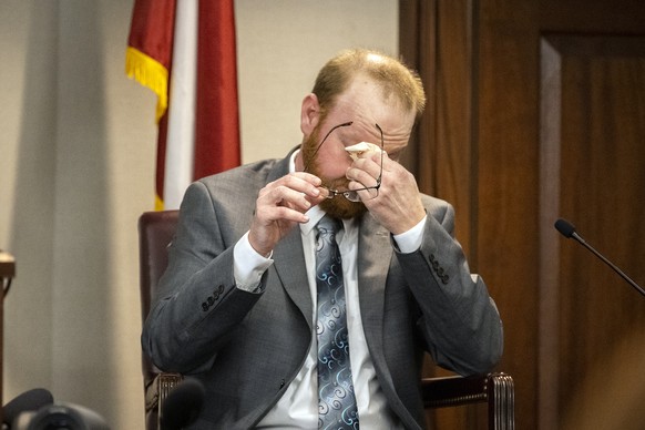 Travis McMichael reacts to questions during his testimony in the trial of he and his father Greg McMichael and neighbor William &quot;Roddie&quot; Bryan in the Glynn County Courthouse, Wednesday, Nov. ...