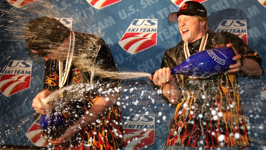U.S. skier Daron Rahlves, right, sprays sparkling wine on Bode Miller, left, during a victory party in the American House in Bormio, northern Italy, Saturday, Feb .5, 2005. Miller won the gold in the  ...