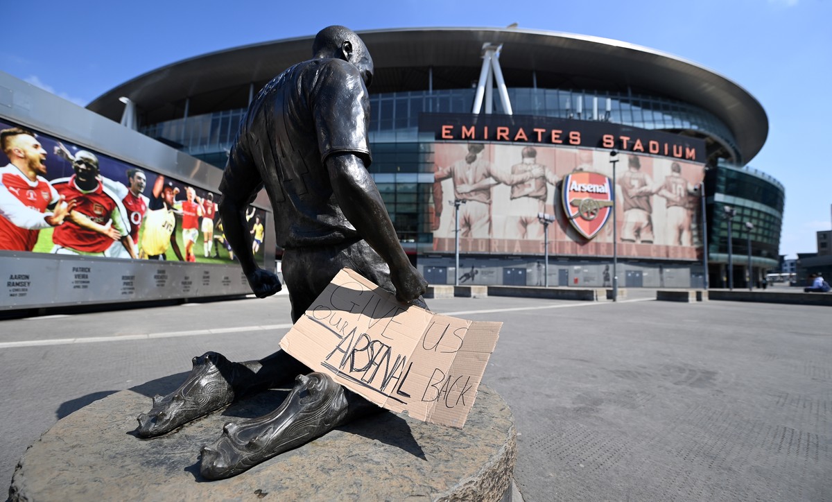 epa09146863 A sign reads, 'Give Us Our Arsenal Back' outside Arsenal's Emirates Stadium in London, Britain, 20 April 2021. Europe's top clubs from England, Italy and Spain have ann ...