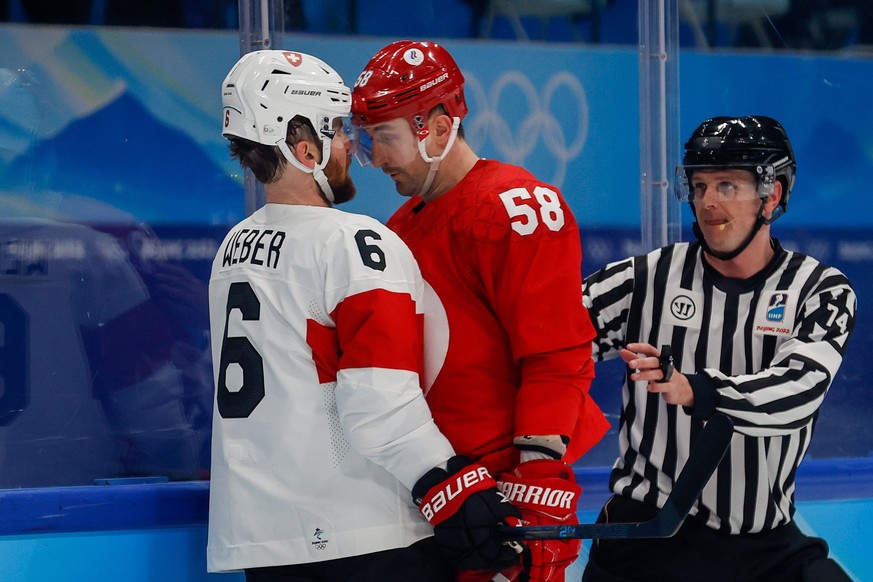 epa09740605 Anton Slepyshev (C) of Russia headbutts Yannick Weber (L) of Switzerland during the Men's Ice Hockey preliminary round match between Russia and Switzerland at the Beijing 2022 Olympic ...