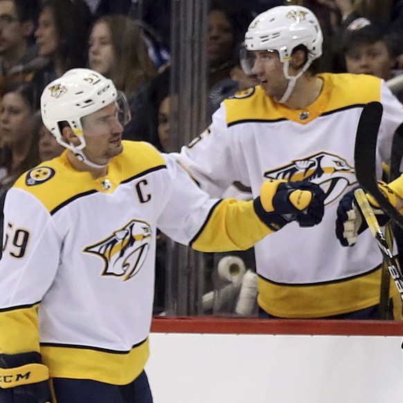 Nashville Predators&#039; Mattias Ekholm (14) celebrates with the bench after he scored against the Winnipeg Jets during the second period of an NHL hockey game Tuesday, Feb. 27, 2018, in Winnipeg, Ma ...