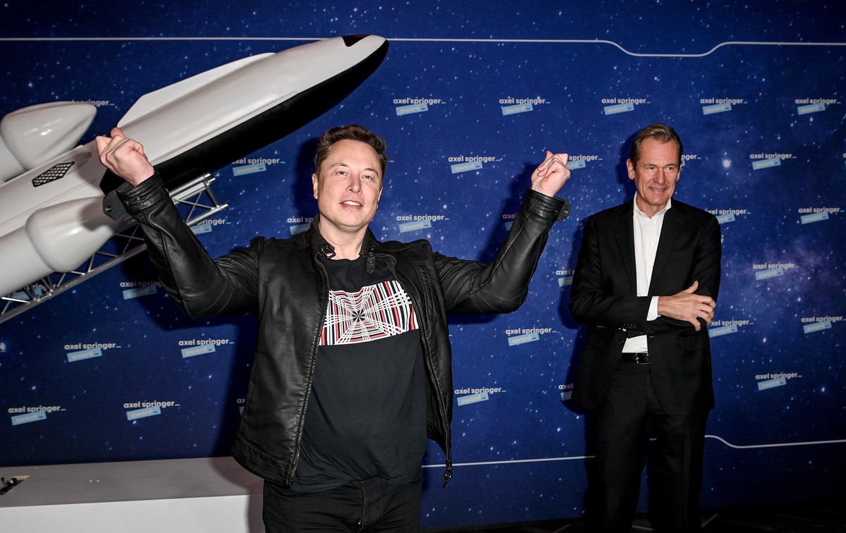 epa08855613 SpaceX owner and Tesla CEO Elon Musk (L) poses as Axel Springer's Chairman of the Board Mathias Doepfner (R) looks on after arriving on the red carpet for the Axel Springer award, in  ...