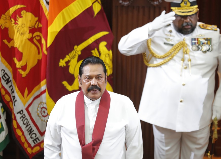 Sri Lanka's new Prime Minister Mahinda Rajapaksa stands for the national anthem at the presidential secretariat in Colombo, Sri Lanka, Thursday, Nov. 21, 2019. President Gotabaya Rajapaksa is expected ...