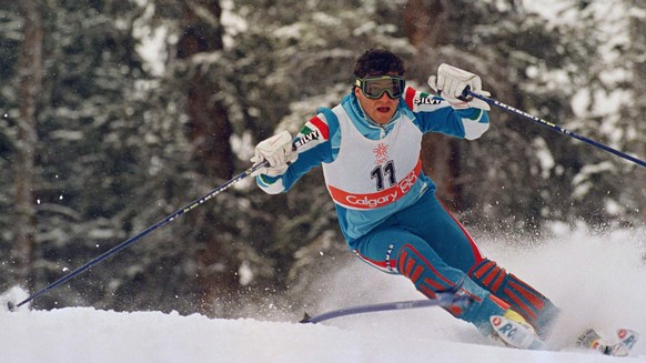 Italian slalom specialist Alberto Tomba swings around the pole as he speeds down the race course to win the gold medal in Olympic special slalom at Mt. Allan, Feb. 27, 1988 in Nakiska, Calgary, Canada ...