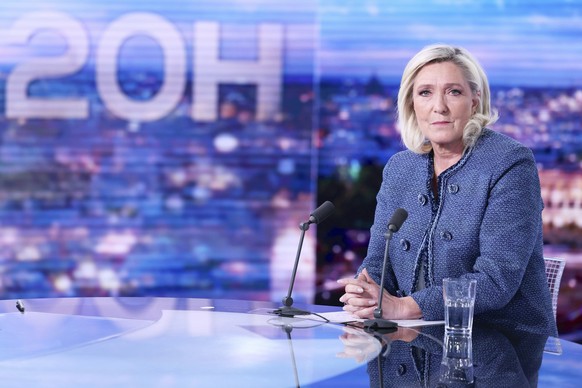Far-right leader Marine Le Pen poses prior to an interview on the evening news broadcast of French TV channel TF1, after a French court convicted Marine Le Pen of embezzlement and barred her from seek ...