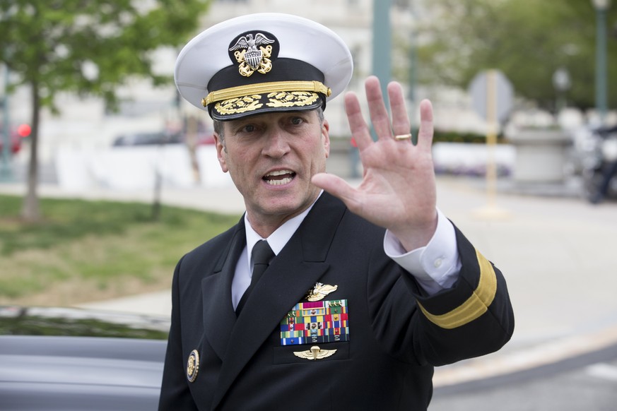 epa06689825 US Navy Rear Admiral Ronny Jackson, US President Donald J. Trump&#039;s nominee to be Secretary of Veteran Affairs, waves to members of the news media following a meeting in the office of  ...