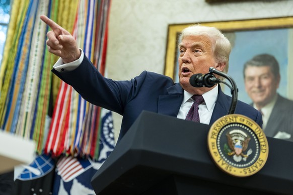 epa12287396 President Donald Trump and Apple CEO Tim Cook (not seen) announce an additional $100 billion Apple investment in the US in the Oval Office of the White House in Washington, DC, USA, 06 Aug ...