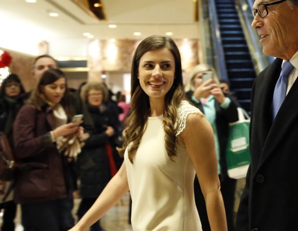 Former Texas Gov. Rick Perry, right, enters Trump Tower with Trump aide Madeleine Westerhout, before meeting with President-elect Donald Trump, Monday, Dec. 12, 2016, in New York. (AP Photo/Kathy Will ...