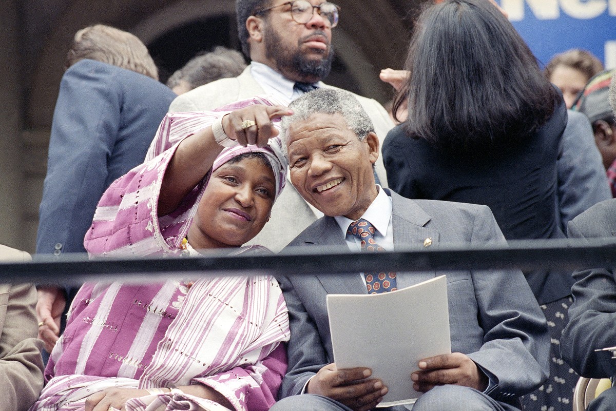 FILE - This June 20, 1990 file photo shows Winnie Mandela pointing out something in the crowd to her husband Nelson Mandela, during a welcoming ceremony at New York's City Hall as they kicked of  ...