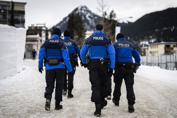 epa10406533 Police officers patrol outside the congress center on the eve of the 52nd annual meeting of the World Economic Forum (WEF) in Davos, Switzerland, 15 January 2023. The meeting brings togeth ...