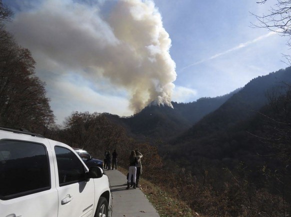 Motorists stop to view wildfires in the Great Smokey Mountains near Gatlinburg, Tennessee, U.S., November 28, 2016. Photo taken November 28, 2016. Courtesy of National Park Services Staff/Handout via  ...