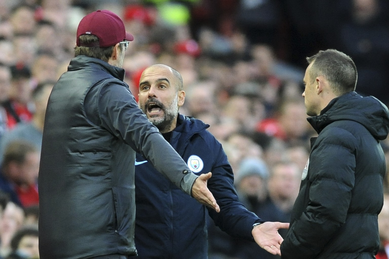 Manchester City manager Josep Guardiola, right, and Liverpool manager Juergen Klopp talk during the English Premier League soccer match between Liverpool and Manchester City at Anfield stadium in Live ...