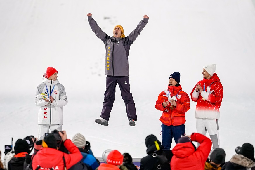 Gold medalist Philipp Raimund, of Germany, celebrates flanked by silver medalist Kacper Tomasiak, of Poland, left, and bronze medalists Ren Nikaido, of Japan, and Gregor Deschwanden, of Switzerland, r ...