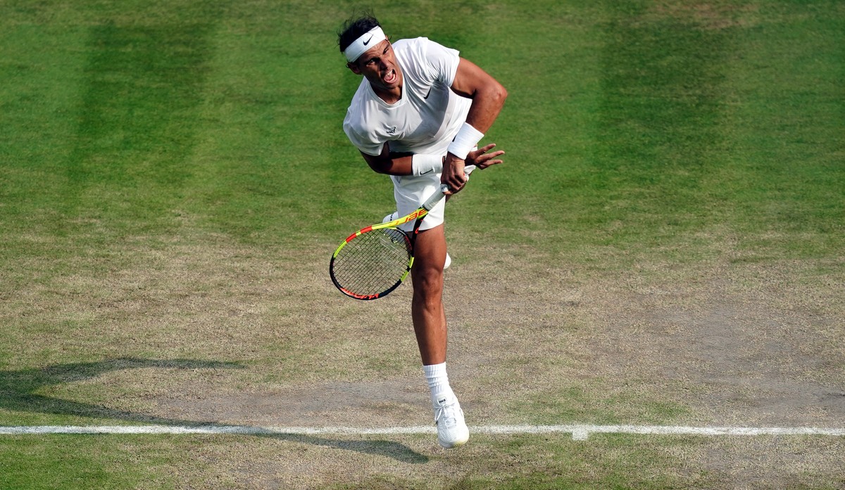 epa07708348 Rafael Nadal of Spain serves to Sam Querrey of the US in their quarter final match during the Wimbledon Championships at the All England Lawn Tennis Club, in London, Britain, 10 July 2019. ...