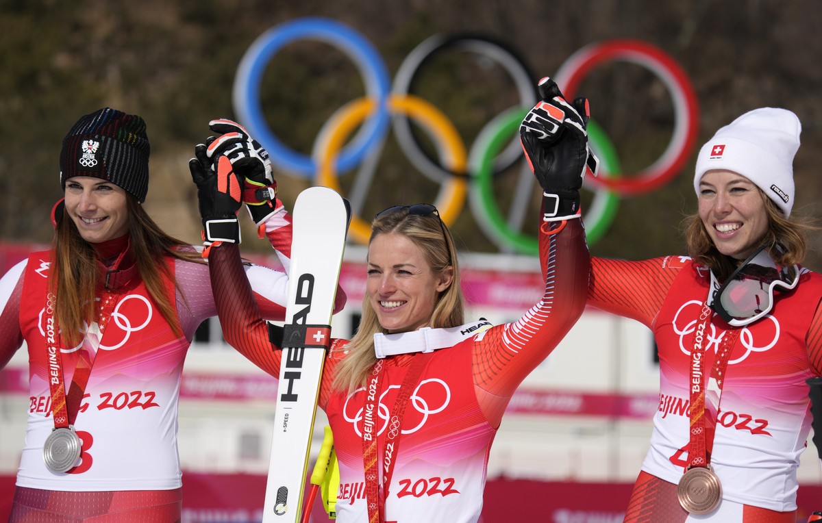 From left: Mirjam Puchner, of Austria, silver, Lara Gut-Behrami, of Switzerland, gold, and Michelle Gisin, of Switzerland, bronze, celebrate during the medal ceremony for the women's super-G at t ...