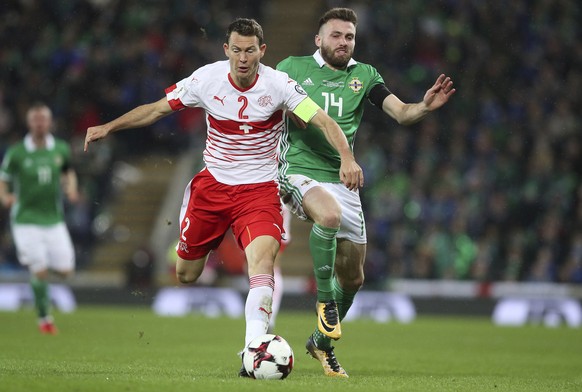 Switzerland&#039;s Stephan Lichtsteiner, left, and Northern Ireland&#039;s Stuart Dallas battle for the ball during the World Cup qualifying play-off first leg soccer match between Northern Ireland an ...