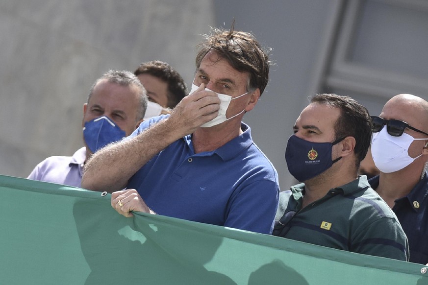 FILE - In this May 17, 2020 file photo, Brazil&#039;s President Jair Bolsonaro, wearing a protective face mask as a precaution against the spread of the new coronavirus, joins in a protest against the ...