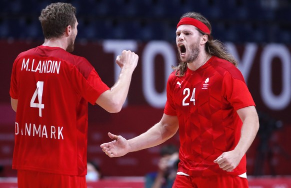 epa09398100 Mikkel Hansen (R) and Magnus Landin (L) of Denmark react during the Men&#039;s Semifinal match between Spain and Denmark during the Handball events of the Tokyo 2020 Olympic Games at the Y ...