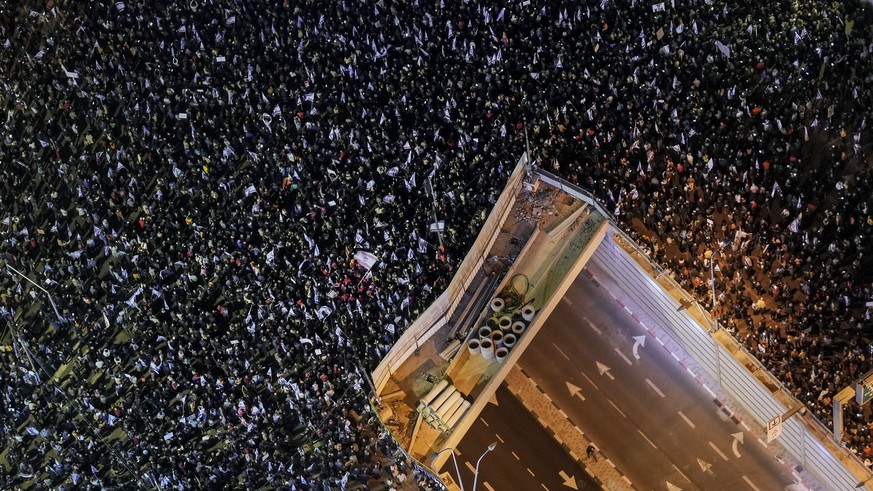 Tens of thousands of Israelis protest against the plans by Prime Minister Benjamin Netanyahu's new government to overhaul the judicial system, in Tel Aviv, Israel, Saturday, Jan. 21, 2023. Israeli med ...