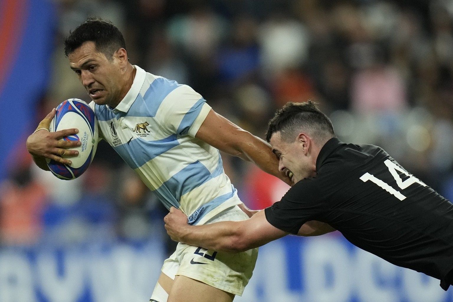 Argentina's Matias Moroni, left is brought down by New Zealand's Will Jordan during the Rugby World Cup semifinal match between Argentina and New Zealand at the Stade de France in Saint-Deni ...