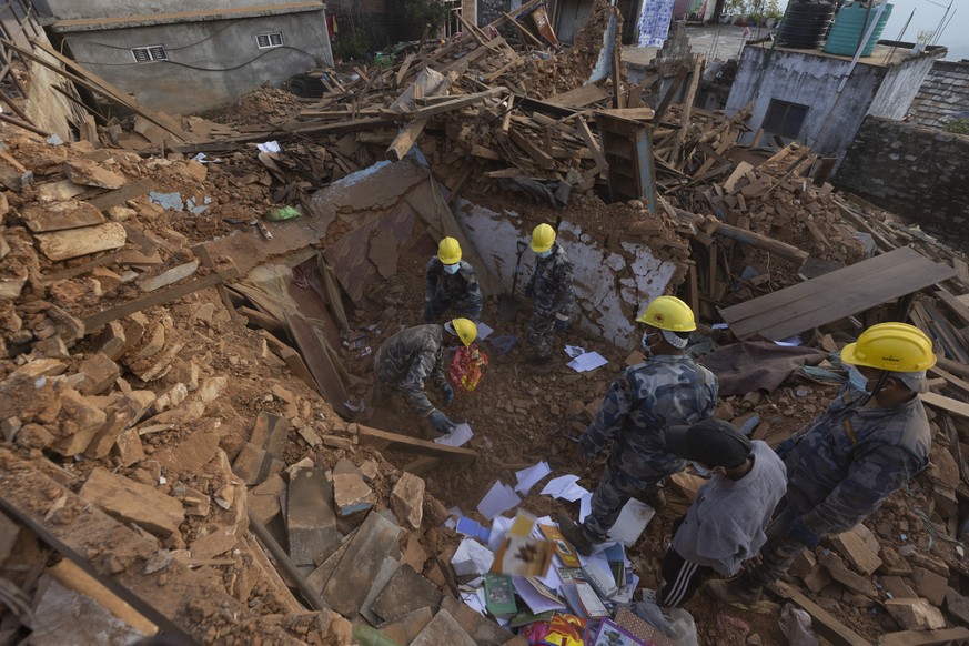 epa10959167 Armed police members search for belongings in a damaged house in Khalanga, a district headquarters of Jajarkot, Nepal, November 5, 2023. The death toll from the 6.4 magnitude earthquake...
