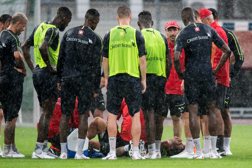 epa06776140 Swiss national team player Granit Xhaka (C, bottom) suffers an injury during a training session in Lugano, Switzerland, 31 May 2018. The Swiss national team prepares for the FIFA World Cup ...