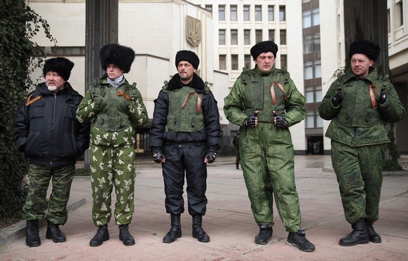*** BESTPIX *** SIMFEROPOL, UKRAINE - MARCH 07:  Cossacks stand guard at the entrance to the Crimean Parliament building on March 7, 2014 in Simferopol, Ukraine. Russian Cossacks, some heavily armed, have taken up guard duties at road checkpoints, border crossings and other key facilities that were previously guarded by local, pro-Russian militants across Crimea in recent days. The Crimean Parliament voted yesterday to hold a referendum on March 16 to determine whether Crimea shall secede from Ukraine and join Russia.  (Photo by Sean Gallup/Getty Images)