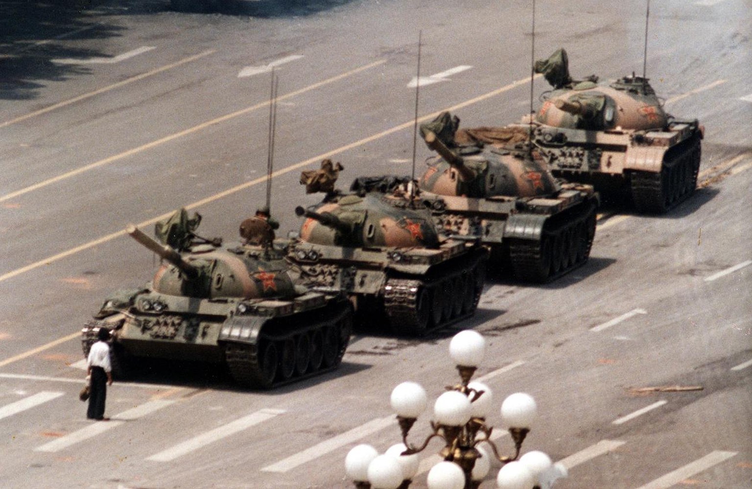 In this June 5, 1989 photo, a Chinese protestor blocks a line of tanks heading east on Beijing&#039;s Cangan Blvd. June 5, 1989 in front of the Beijing Hotel. The man, calling for an end to the violen ...