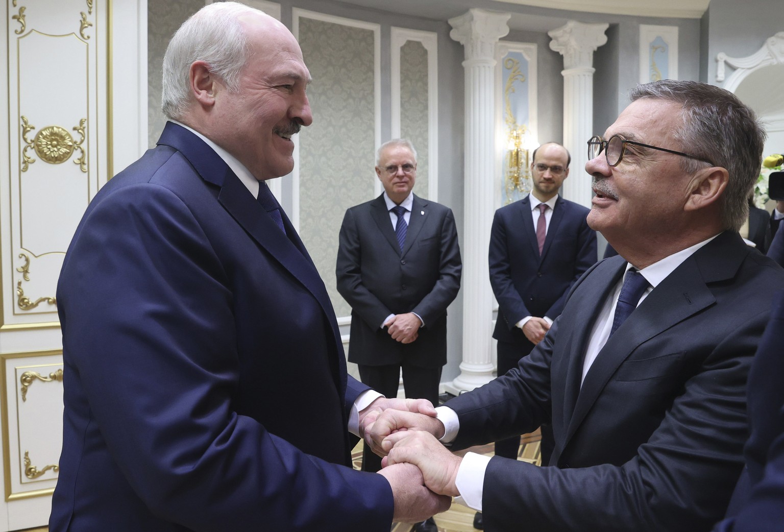 Belarusian President Alexander Lukashenko, left, greets International Ice Hockey Federation President Rene Fasel during their meeting in Minsk, Belarus, Monday, Jan. 11, 2021. (Nikolai Petrov/BelTA Po ...