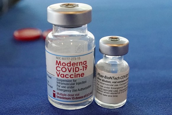 FILE - This Sept. 21, 2021 file photo shows vials of the Pfizer and Moderna COVID-19 vaccines in Jackson, Miss. Moderna is suing its main competitors Pfizer and the German drugmaker BioNTech, accusing ...