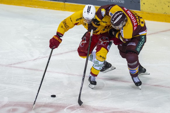 Samuel Erni (SCL), gauche, lutte pour le puck avec Dmytro Timashov (GSHC), droite, lors du match du championnat suisse de hockey sur glace de National League entre Geneve-Servette HC, GSHC, et SCL Tig ...