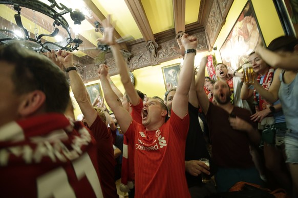 Liverpool supporters celebrate the victory in a pub at the final whistle of the Champions League final soccer match between Tottenham Hotspur and Liverpool at the Wanda Metropolitano Stadium in Madrid ...