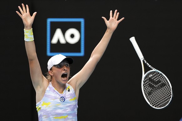 Iga Swiatek of Poland celebrates after defeating Kaia Kanepi of Estonia in their quarterfinal match at the Australian Open tennis championships in Melbourne, Australia, Wednesday, Jan. 26, 2022. (AP P ...