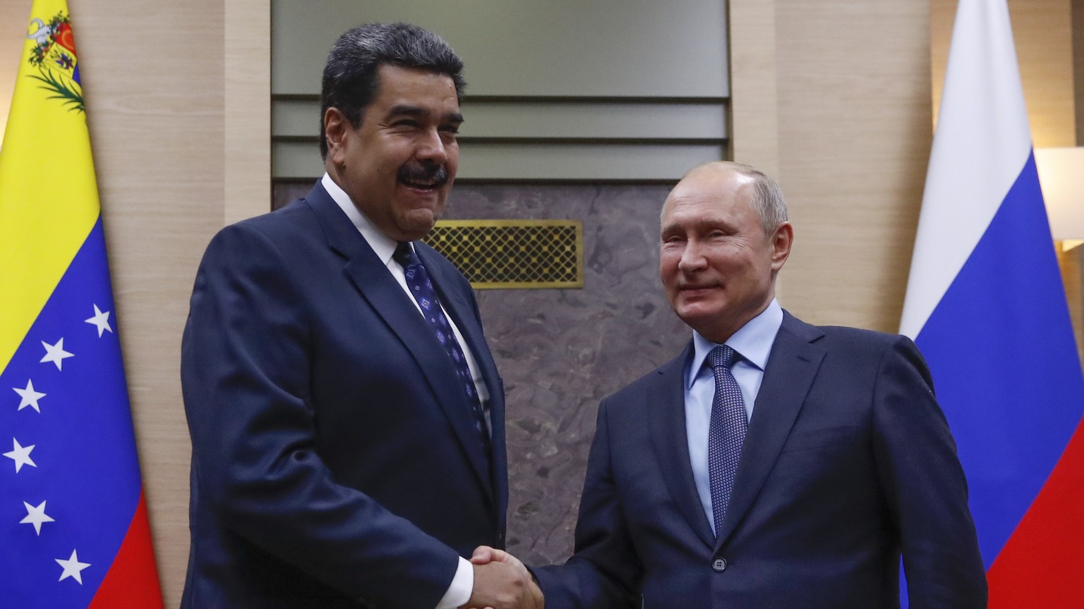 epa07209755 Russian President Vladimir Putin (R) shakes hands with Venezuelan President Nicolas Maduro (L) during a meeting at the Novo-Ogaryovo state residence outside Moscow, Russia, 05 December 201 ...