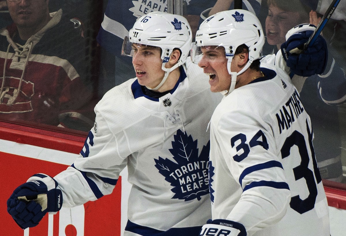 Toronto Maple Leafs' Auston Matthews (34) celebrates with teammate Mitchell Marner after scoring against the Montreal Canadiens during the third period of an NHL hockey game in Montreal, Saturday ...