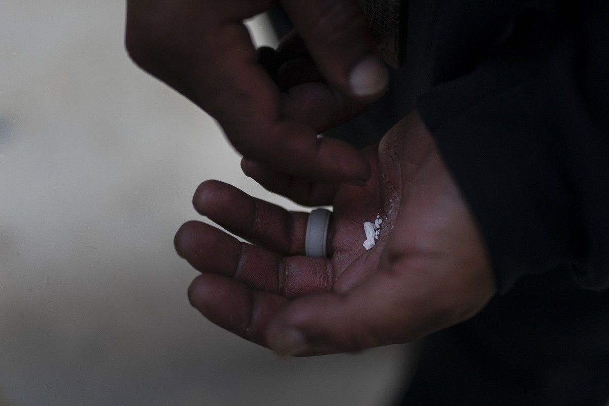 A homeless addict holds pieces of fentanyl in Los Angeles, Thursday, Aug. 18, 2022. Use of the powerful synthetic opioid that is cheap to produce and is often sold as is or laced in other drugs, has e ...
