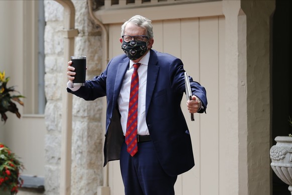 Ohio Governor Mike DeWine shrugs his shoulders in response to a reporter&#039;s question about him testing positive for COVID-19 Thursday, Aug. 6, 2020, in Bexley, Ohio. The Ohio governor&#039;s posit ...