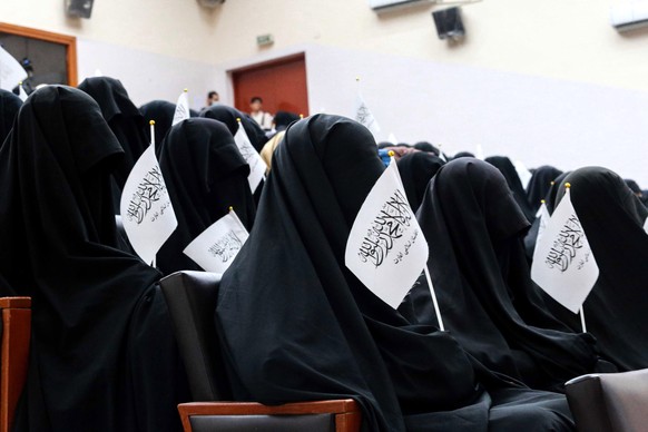 epa09461022 Afghan students listen to women speakers prior to their pro-Taliban rally outside the Shaheed Rabbani Education University in Kabul, Afghanistan, 11 September 2021. The United States envoy ...